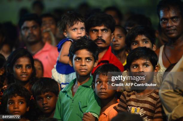 Indian children watch as young Indian artists perform a traditional Ram Leela drama, which narrates the life of Hindu god Rama , as they celebrate...