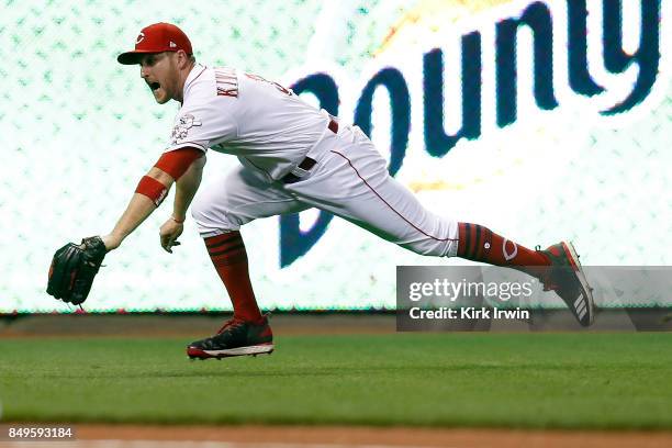 Patrick Kivlehan of the Cincinnati Reds dives for a ball hit in to the outfield during the game against the Pittsburgh Pirates at Great American Ball...