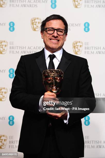 David O Russell with the award for Best Adapted Screenplay for 'Silver Linings Playbook' in the press room at the 2013 British Academy Film Awards at...