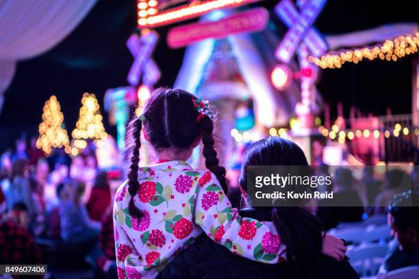 mother and child are waiting for santa at a christmas tree lighting ceremony. - traditional festival stock-fotos und bilder