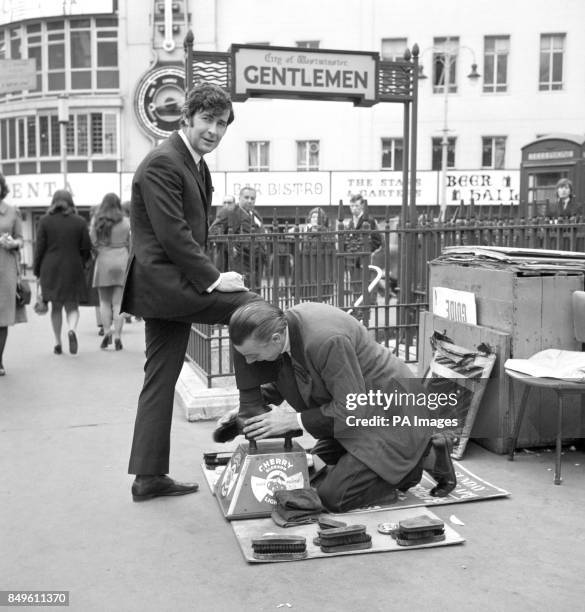 Dublin-born comedian Dave Allen stopped off in Leicester Square in London for a shoe-shine. He was en-route to the nearby Talk Of The Town...