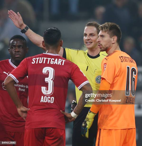 Dennis Aogo of Stuttgart and goalkeeper Ron-Robert Zieler of Stuttgart argue with referee Soeren Storks after he awards a penalty to...