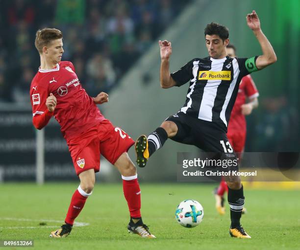 Dzenis Burnic of Stuttgart fights for the ball with Lars Stindl of Moenchengladbach during the Bundesliga match between Borussia Moenchengladbach and...
