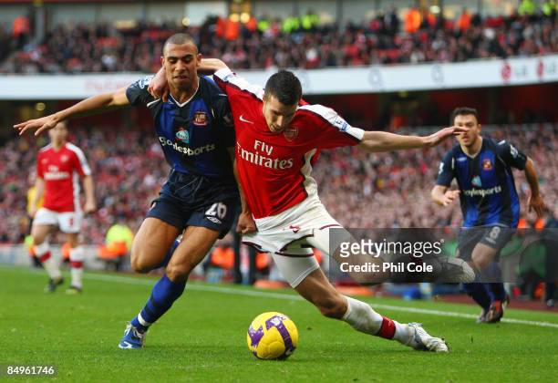 Anton Ferdinand of Sunderland is challenged by Robin Van Persie of Arsenal during the Barclays Premier League match between Arsenal and Sunderland at...