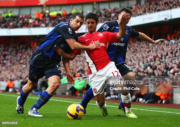 Carlos Vela of Arsenal is challenged by Tal Ben-Haim and Steed Malbranque of Sunderland during the Barclays Premier League match between Arsenal and...