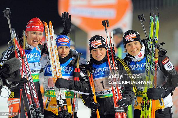 Kati Wilhelm, Martina Beck, Andrea Henkel and Magdalena Neuner of Germany pose for photographers following the womens relay race at the IBU World...