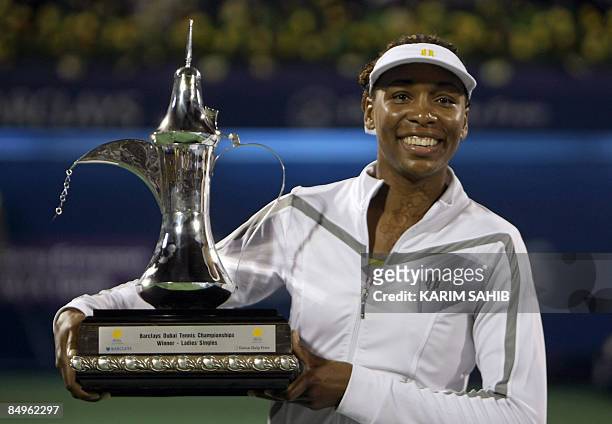 Venus Williams of the US holds her trophy after beating France's Virginie Razzano during their WTA Dubai Tennis Championships final tennis match in...