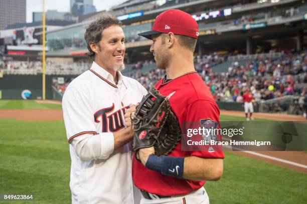 Former pitcher Joe Nathan of the Minnesota Twins meets with Joe Mauer following a first pitch against the Kansas City Royals on September 1, 2017 at...