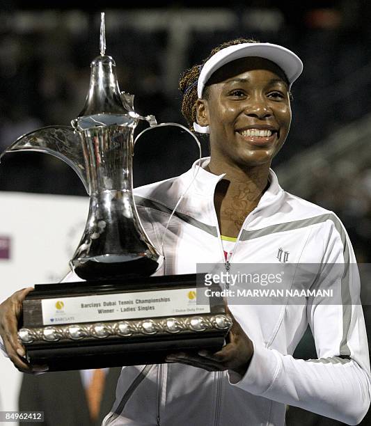Venus Williams of the US holds her trophy after beating France's Virginie Razzano in the final match of the WTA Dubai tennis championships in the...
