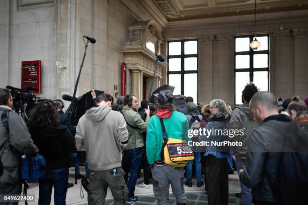 People attend in Paris, France, on 19 September 2017 during opening of the trial in the Quai de Valmy case, where a police car was set on fire during...