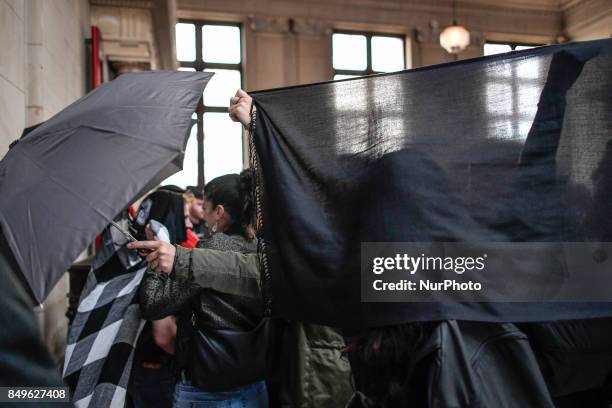 Anti-Fascists blocked the view of journalists with umbrella and scarfs in Paris, France, on 19 September 2017 during opening of the trial in the Quai...