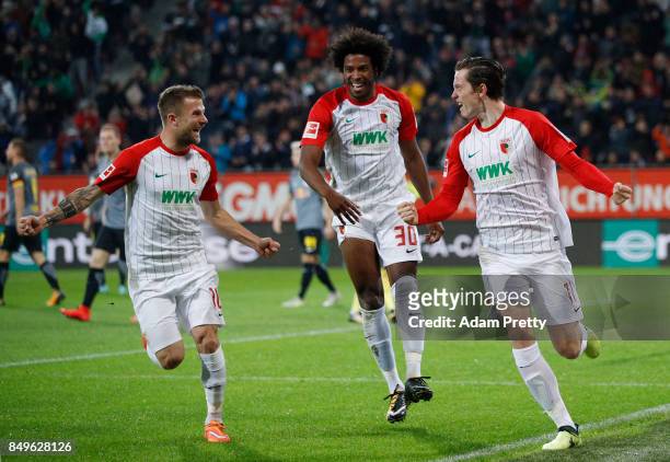 Michael Gregoritsch of Augsburg celebrates after he scored his teams first goal to make it 1:0 with Caiuby of Augsburg and Daniel Baier of Augsburg...