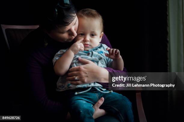 12 month old fraternal twin is embraced by mother in a formal portrait - family formal portrait stock pictures, royalty-free photos & images