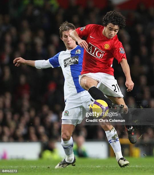Rafael Da Silva of Manchester United clashes with Morten Gamst Pedersen during the Barclays Premier League match between Manchester United and...