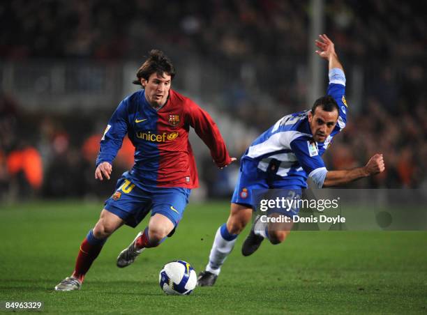 Lionel Messi of Barcelona speeds past Moises Hurtado of Espanyol during the La Liga match between Barcelona and Espanyol at the Camp Nou stadium on...