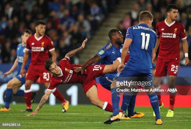 Philippe Coutinho of Liverpool tangles with Wes Morgan of Leicester City during the Carabao Cup third round match between Leicester City and...