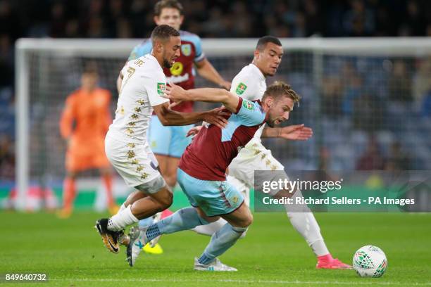 Leeds United's Kemar Roofe and Burnley's Charlie Taylor battle for the ball during the Carabao Cup, third round match at Turf Moor, Burnley.