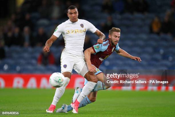 Leeds United's Jay-Roy Grot and Burnley's Charlie Taylor battle for the ball during the Carabao Cup, third round match at Turf Moor, Burnley.