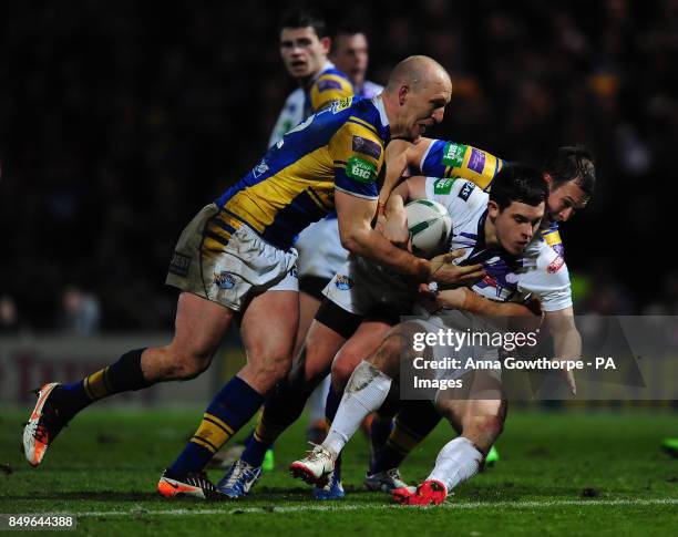 Salford City Reds' Niall Evalds is tackled by Leeds Rhinos' Carl Ablett and Danny McGuire during the Super League match at Headingley Carnegie, Leeds.