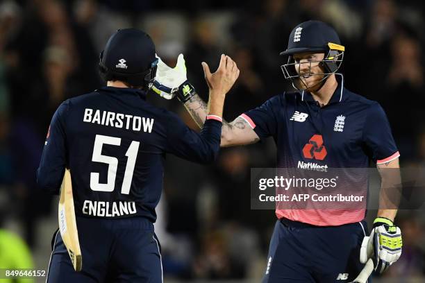 England's Jonny Bairstow and England's Ben Stokes celebrate victory after the first One-Day International cricket match between England and the West...
