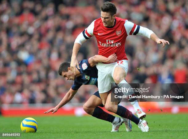 Arsenal's Olivier Giroud and Blackburn Rover's Jason Lowe during the FA Cup fifth round match at The Emirates Stadium, London.