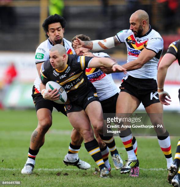 Castleford Tigers' Justin Carney is tackled by Bradford Bulls' Manase Manuokafoa and Chev Walker during the Super League match at the Provident...