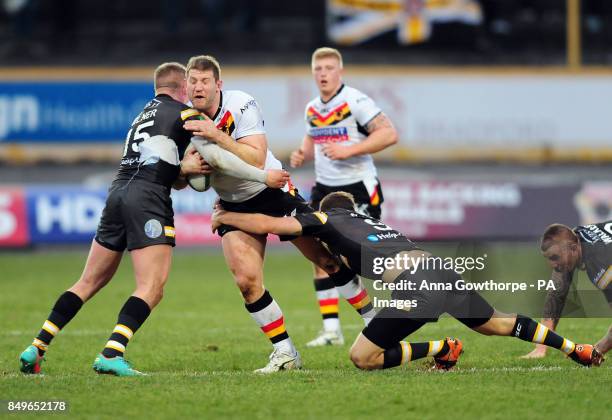 Bradford Bulls' Nick Scruton is tackled by Castleford Tigers' Adam Milner and Daryl Clark during the Super League match at the Provident Stadium,...