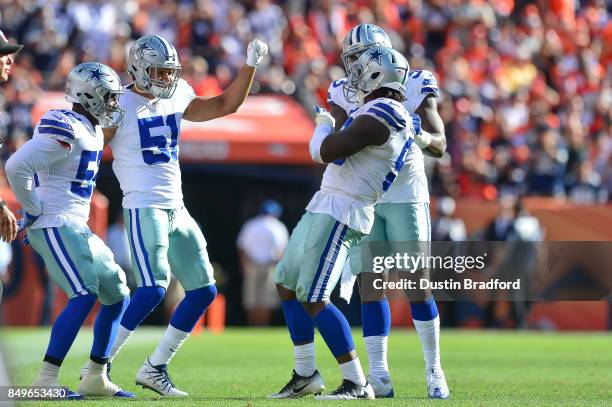 Dallas Cowboys defensive players, including Justin Durant, Kyle Wilber, and Benson Mayowa celebrate after a play against the Denver Broncos at Sports...