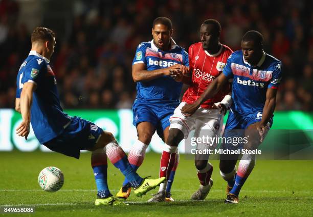 Famara Diedhiou of Bristol City attempts to keep possession while under pressure from Glen Johnson of Stoke City and Kurt Zouma of Stoke City during...