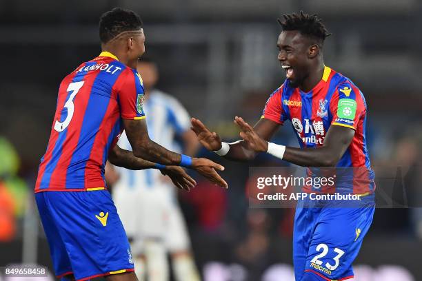 Crystal Palace's Senegalese defender Pape Souare gestures to Crystal Palace's Dutch defender Patrick van Aanholt as he starts the second half after...