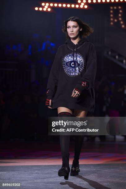 Model Bella Hadid presents a creation by US designer Tommy Hilfiger during a catwalk show for the Spring/Summer 2018 collection on the fifth and...