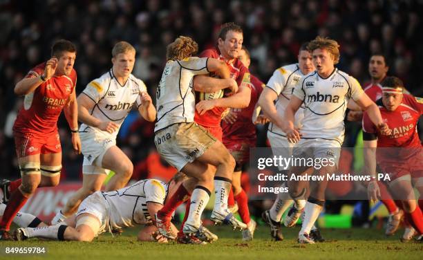 London Welsh's Jonathan Mills is tackled by Sale Sharks' Dan Baird during the Aviva Premiership match at the Kassam Stadium, Oxford.