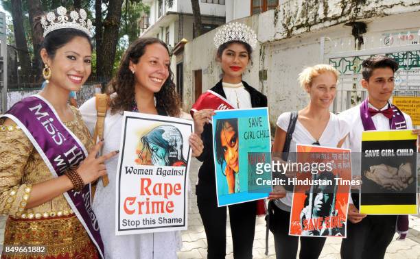 Shilpa Negi, Miss Himalaya 2017, Neha Chaudhary, Miss Glory of India 2017 and foreign tourists hold placard to show their support towards crime...