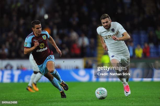 Stuart Dallas of Leeds and Ashley Westwood of Burnley in action during the Carabao Cup Third Round match between Burnley and Leeds United at Turf...