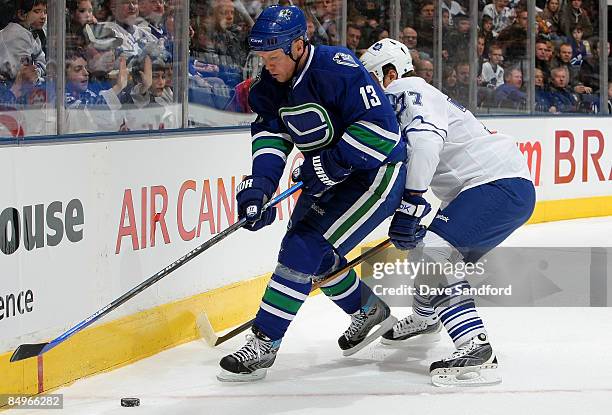 Mats Sundin of the Vancouver Canucks battles for the puck with Pavel Kubina of the Toronto Maple Leafs during their NHL game at the Air Canada Centre...