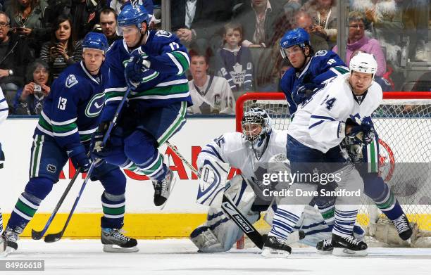 Vesa Toskala of the Toronto Maple Leafs is screaned by a leaping Ryan Kesler of the Vancouver Canucks as Steve Bernier, Mats Sundin of the Vancouver...