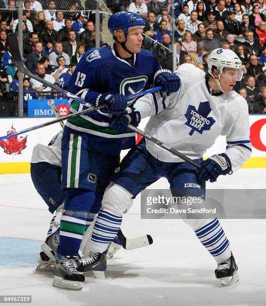 Mats Sundin of the Vancouver Canucks battles with Luke Schenn of the Toronto Maple Leafs during their NHL game at the Air Canada Centre February 21,...