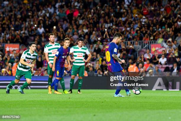 Lionel Messi of FC Barcelona scores his team's first goal from the penalty spot during the La Liga match between Barcelona and SD Eibar at Camp Nou...