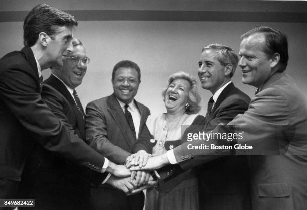 From left, Boston Mayoral Candidates John Nucci, Tom Menino, Bruce Bolling, Rosaria Salerno, Bob Rufo and James Brett join hands during a forum...