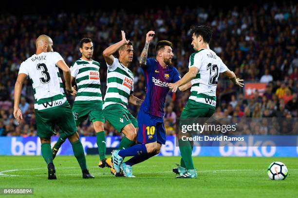 Lionel Messi of FC Barcelona competes for the ball with four Eibar players during the La Liga match between Barcelona and SD Eibar at Camp Nou on...