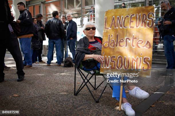 Woman held a placard reading 'Unbowed whistleblower' in support of Celine Boussie, French whistleblower and president of the association...