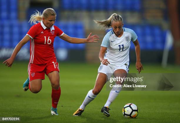 Toni Duggan of England beats Marina Fedorova of Russia during the FIFA Women's World Cup Qualifier between England and Russia at Prenton Park on...