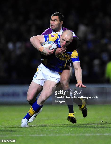 Leeds Rhinos' Carl Ablett is tackled by Melbourne Storm's Justin O'Neill during the World Club Challenge at Headingley Carnegie, Leeds.