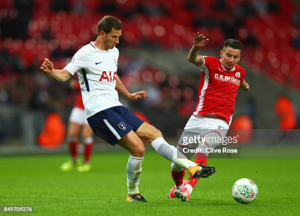 Jan Vertonghen of Tottenham Hotspur is challenged by Adam Hammill of Barnsley during the Carabao Cup Third Round match between Tottenham Hotspur and...