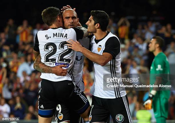 Simone Zaza of Valencia celebrates scoring his team's third goal with his teammates Santi Mina and Goncalo Guedes during the La Liga match between...