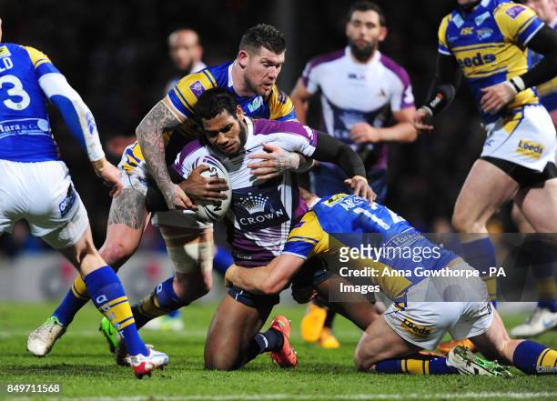 Melbourne Storm's Sisa Waqa is tackled by Leeds Rhinos' Brett Delaney and Carl Ablett during the World Club Challenge at Headingley Carnegie, Leeds.