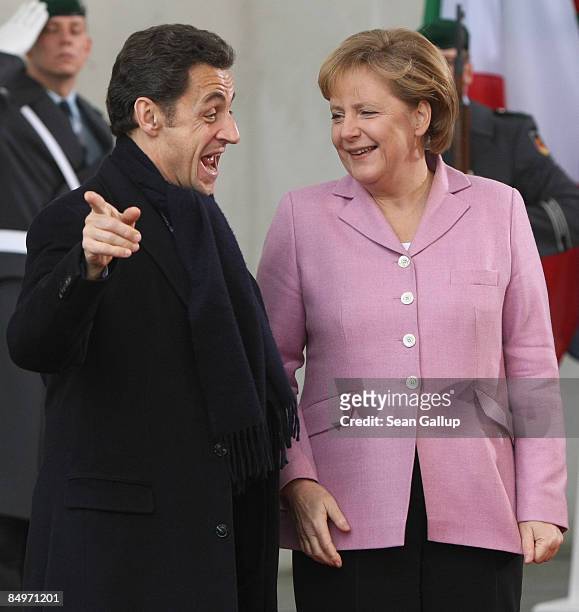 German Chancellor Angela Merkel greets French President Nicolas Sarkozy upon his arrival for a meeting of European Union leaders at the Chancellery...