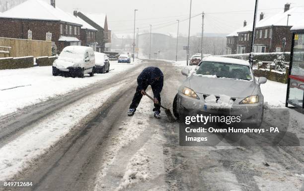 Car struggles in the cold conditions in Wallsend near Newcastle as snow and sleet hit parts of north England today as freezing winds sweep across...