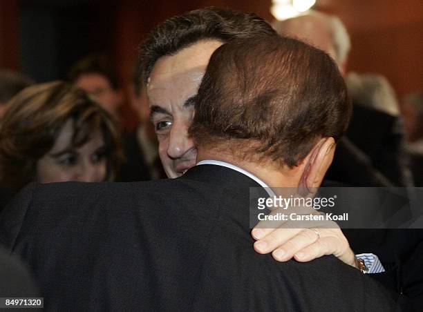 French President Nicolas Sarkozy welcomes Italian Prime Minister Silvio Berlusconi upon their arrival for a meeting of European Union leaders at the...