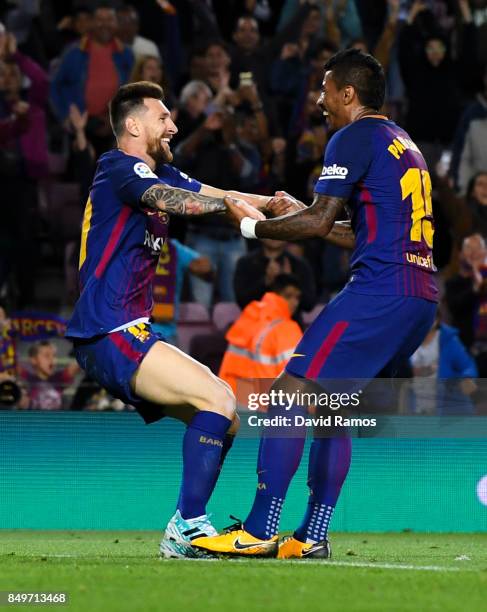 Lionel Messi of FC Barcelona celebrates with his team mate Paulinho after scoring his team's fifth goal during the La Liga match between Barcelona...